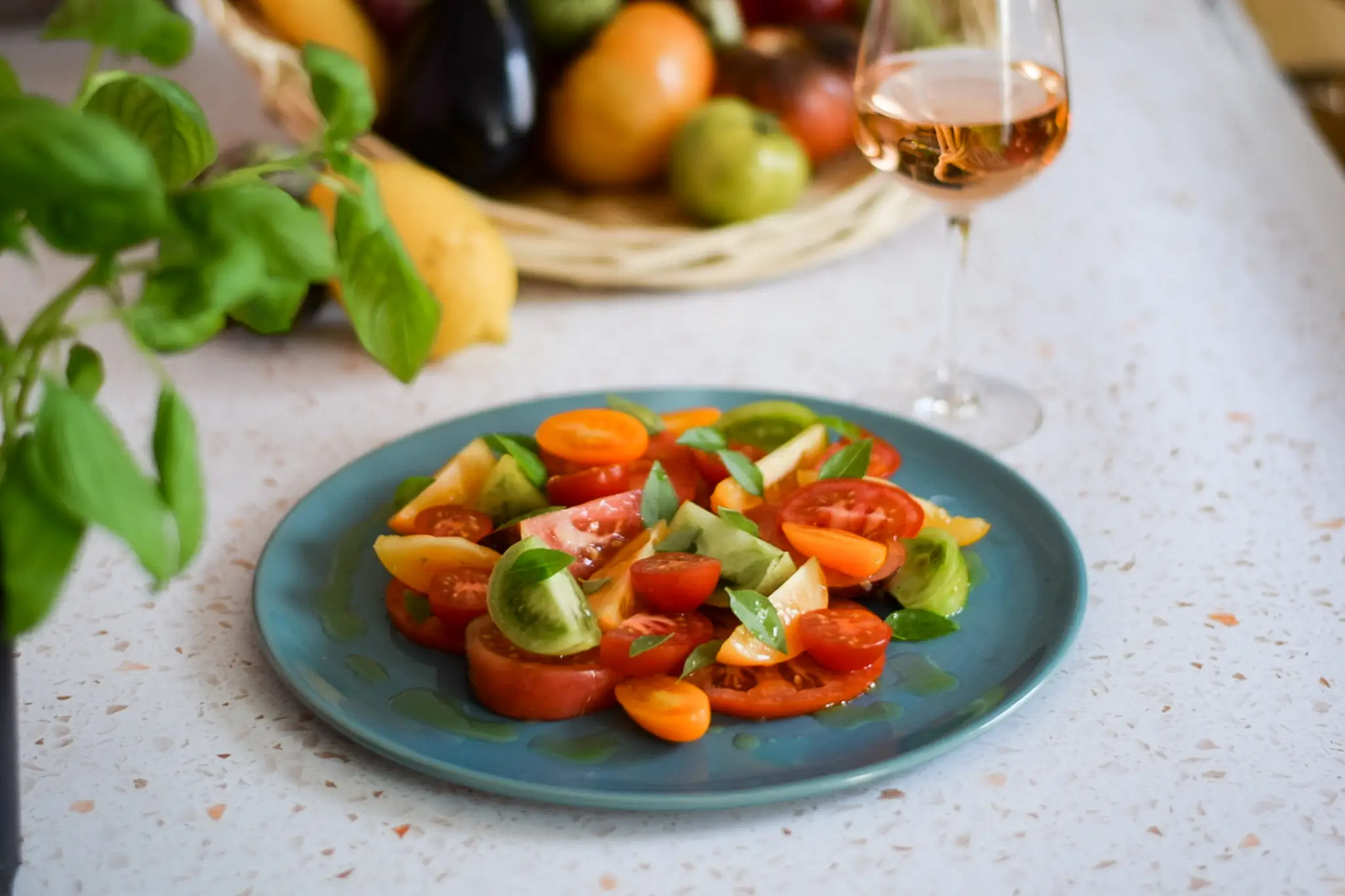 Colourful South of France tomatoes and rosé glass by villa chef for holiday meals